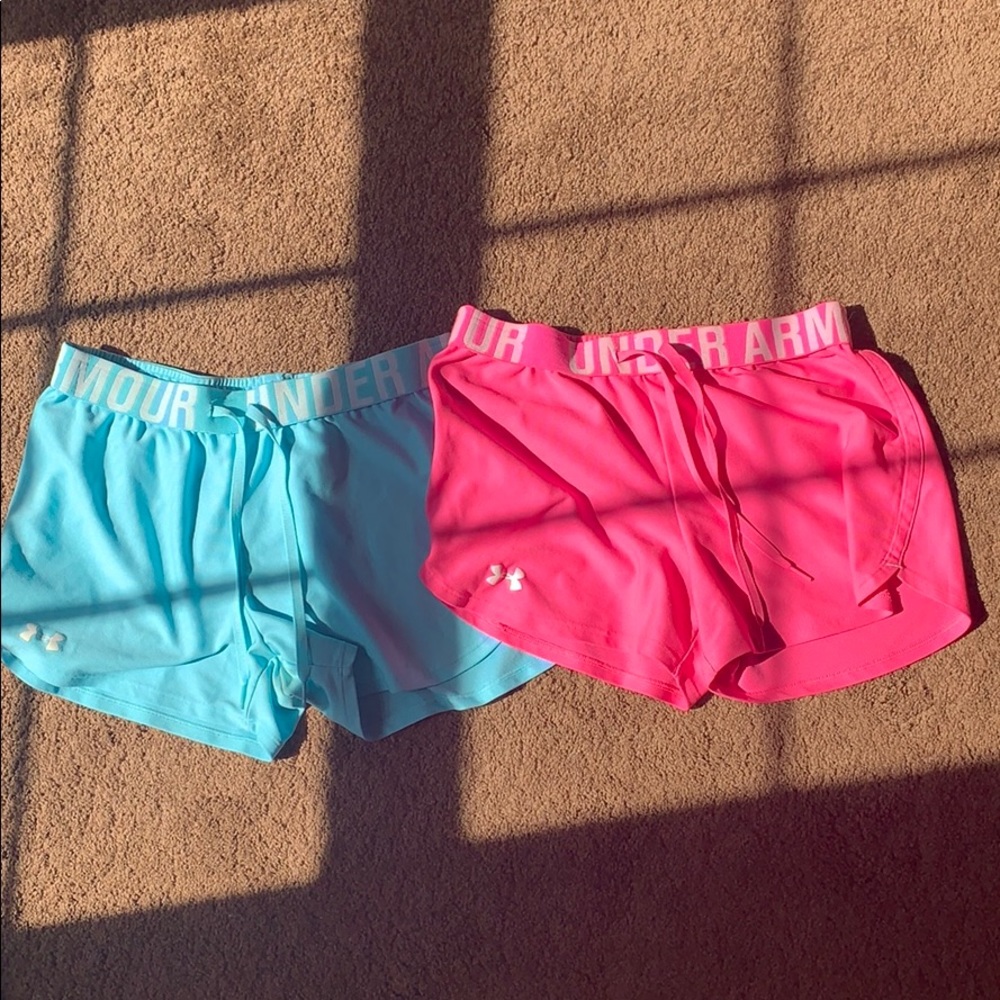 a pair of pink and blue under armour shorts